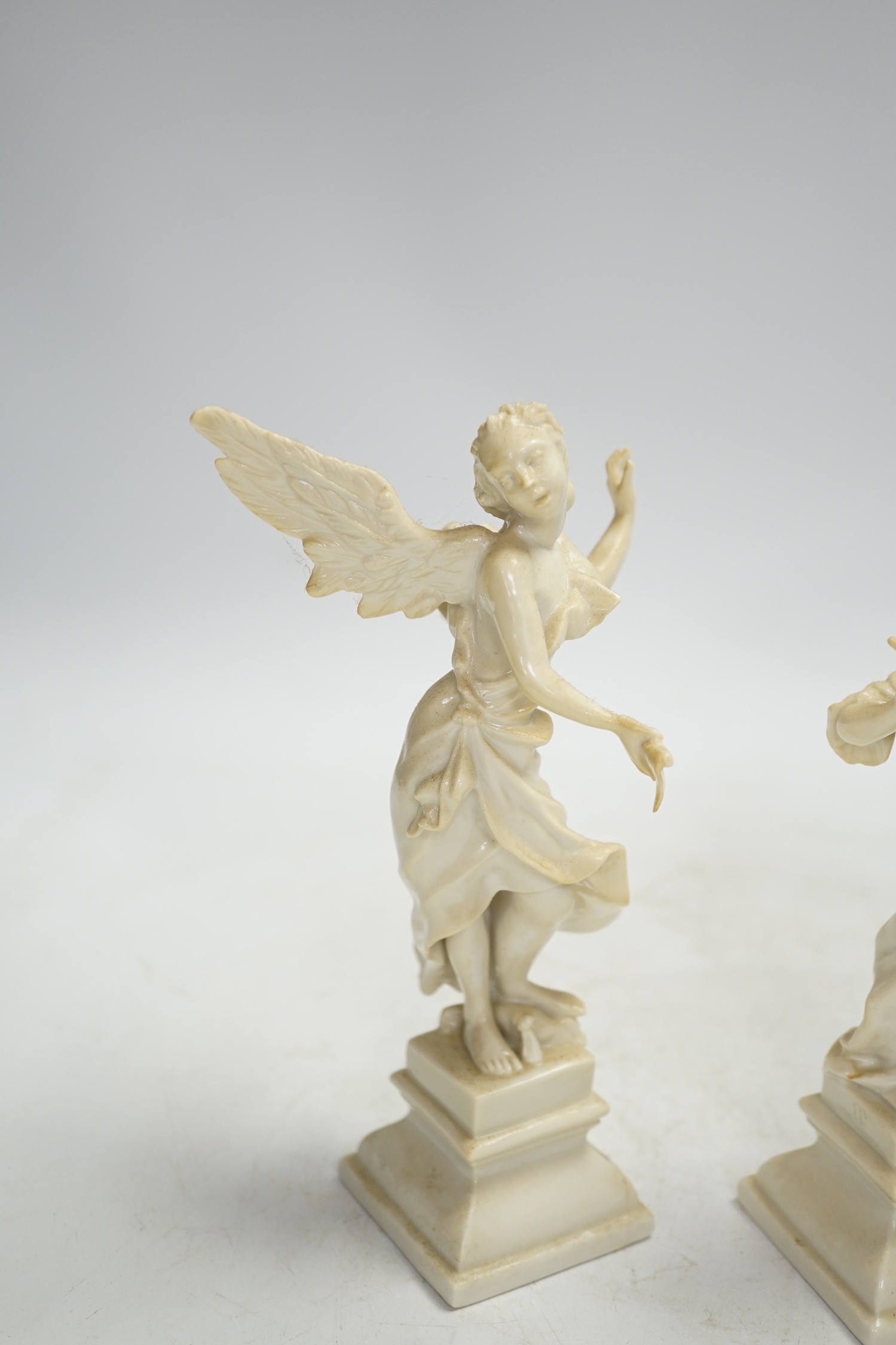 A pair of Nymphenburg white glazed figures of angels, tallest 18.5cm high. Condition - grubby, otherwise good